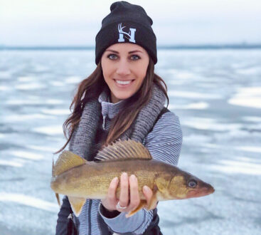Woman holding Walleye - Ice fishing
