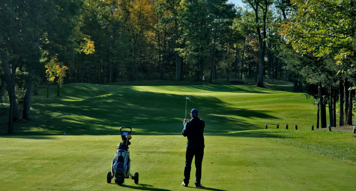Man watching golf shot