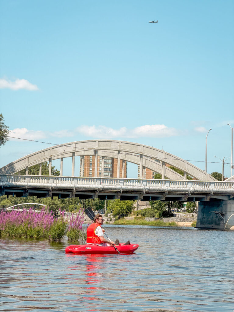 A kayaker paddles in the Moira River in Belleville, Ontario.